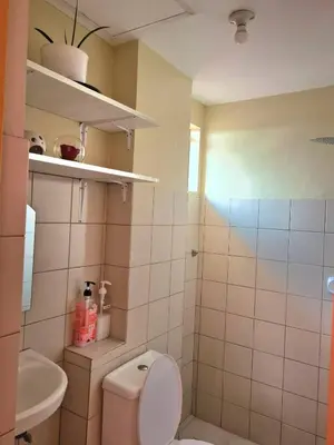 a bathroom with a toilet and a sink at Budget Friendly Condo for Rent in Valley Mansions in Cainta