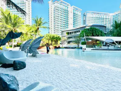 a resort with a swimming pool and some buildings at Azure Pool View w/ Netflix & Wifi Boracay Tower in Manila
