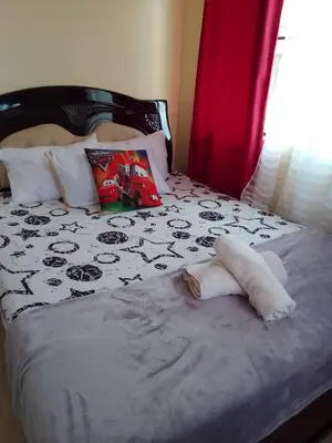 a bed with a towel laying on it at Pet Friendly Staycation near Villa Ardin in Cainta