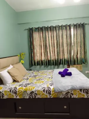 a bedroom with a bed with a purple stuffed animal on it at Affordable Transient in Valley Golf near Emperor Events Place in Cainta