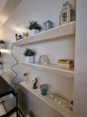a room with white shelves with plants on them at Palm Tree Villas Condominium by Beth in Manila