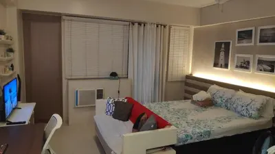 a bedroom with a bed and a desk and a table at Palm Tree Villas Condominium by Beth in Manila