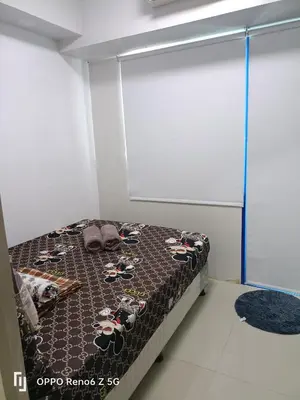 a bedroom with a bed with a bedspread with cows on it at Jamescrabsea residences in Manila