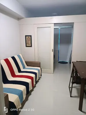 a room with two beds and a sliding glass door at Jamescrabsea residences in Manila