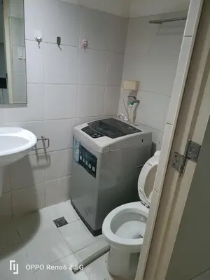 a small bathroom with a toilet and a sink at Jamescrabsea residences in Manila