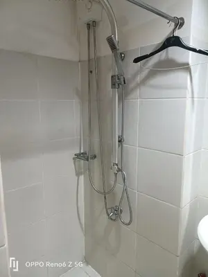 a shower with a shower head in a bathroom at Jamescrabsea residences in Manila