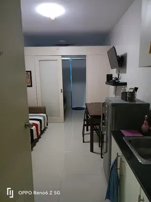 a small room with a kitchen and a dining room at Jamescrabsea residences in Manila