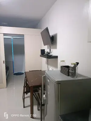 a small kitchen with a table and a counter top at Jamescrabsea residences in Manila
