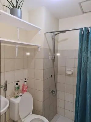 a bathroom with a shower and a toilet and a sink at Pet Friendly Transient in Valley Golf near Emperor Events Place in Cainta
