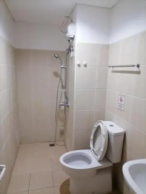 a bathroom with a toilet and a shower and a sink at Roxas Blvd Stunning Studio Condo Near US Embassy in Manila