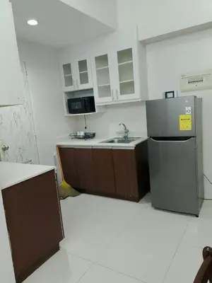 a kitchen with a sink and a refrigerator at Roxas Blvd Stunning Studio Condo Near US Embassy in Manila