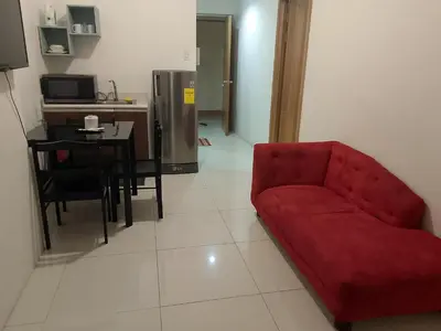 a living room with a red couch and a table at Roxas Blvd Stunning Studio Condo Near US Embassy in Manila