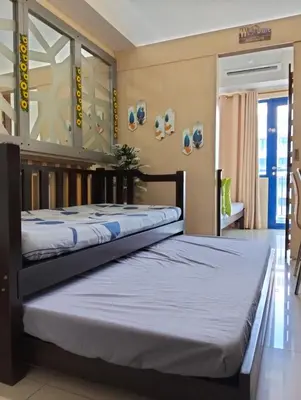 two twin beds in a room with at 5 Years Legit Staycation Infront Of Moa, Sea Residences Tower A, Near Smx, Arena, Dfa, World Trade, PICC, AYALA MALL, NAIA in Manila