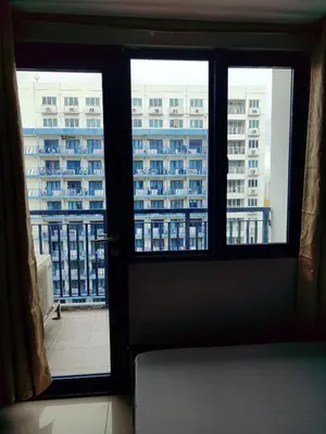 a door with a view of a large building at 5 Years Legit Staycation Infront Of Moa, Sea Residences Tower A, Near Smx, Arena, Dfa, World Trade, PICC, AYALA MALL, NAIA in Manila