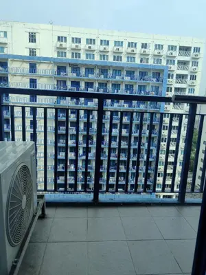 a view of a building from a balcony at 5 Years Legit Staycation Infront Of Moa, Sea Residences Tower A, Near Smx, Arena, Dfa, World Trade, PICC, AYALA MALL, NAIA in Manila