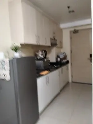 a kitchen with white cabinets and a refrigerator at 5 Years Legit Staycation Infront Of Moa, Sea Residences Tower A, Near Smx, Arena, Dfa, World Trade, PICC, AYALA MALL, NAIA in Manila