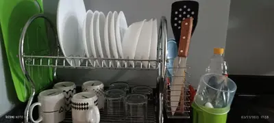 a dish rack with plates and utensils in a kitchen at 5 Years Legit Staycation Infront Of Moa, Sea Residences Tower A, Near Smx, Arena, Dfa, World Trade, PICC, AYALA MALL, NAIA in Manila