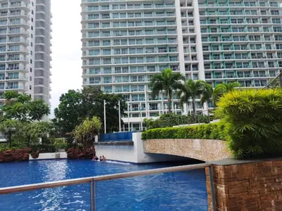 a pool in the middle of a city with tall buildings at Happirest at Azure Urban Resort Residences, Paranaque City in Manila