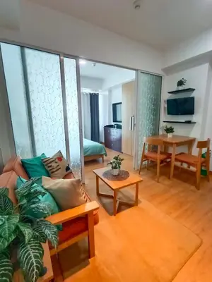 a living room with a couch and a table at Happirest at Azure Urban Resort Residences, Paranaque City in Manila