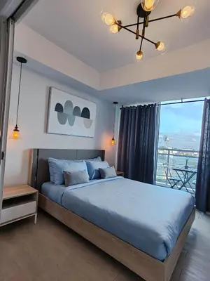 a bedroom with a large bed and a large window at Happirest at Azure Urban Resort Residences, Paranaque City in Manila