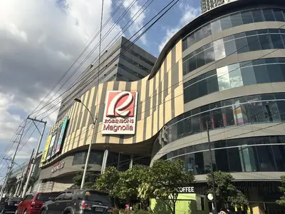 a large building with a sign on the side of it at King Bed Suite at Pine Crest #T3-439 near Mall in Manila