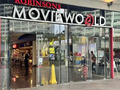 a moxworth store with a sign on the front of it at King Bed Suite at Pine Crest #T3-439 near Mall in Manila