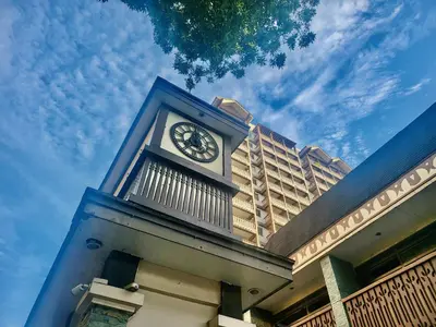 a clock tower on top of a building at King Bed Suite at Pine Crest #T3-439 near Mall in Manila