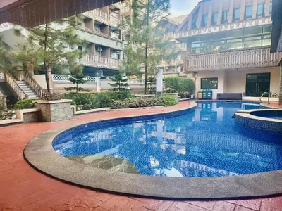 a large swimming pool in front of a building at King Bed Suite at Pine Crest #T3-439 near Mall in Manila