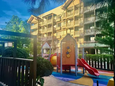 a playground in front of a apartment building at King Bed Suite at Pine Crest #T3-439 near Mall in Manila