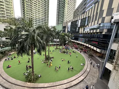 a group of people in a park in a city at King Bed Suite at Pine Crest #T3-439 near Mall in Manila