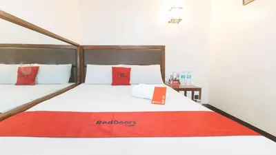 a bedroom with a bed with red pillows on it at RedDoorz @ Riches Holiday Hotel Avenida in Manila