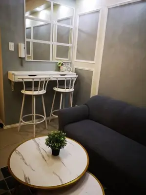 a living room with a couch and a table at Serenity Cove MOA in Manila