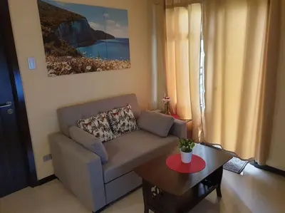 a living room with a couch and a coffee table at The Radiance by Dominga in Manila