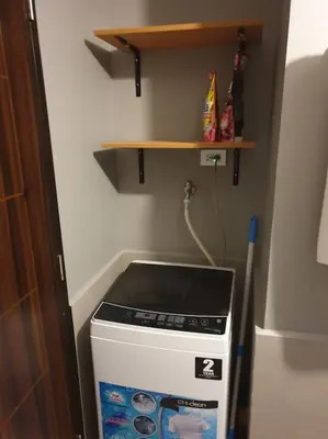 a stove in a small kitchen with a shelf at The Radiance by Dominga in Manila