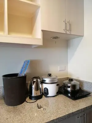 a kitchen with two pots and pans on a counter at Stanford Suites 2 Lilian in Silang