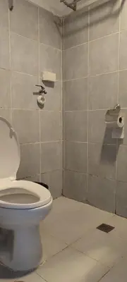 a bathroom with a toilet and a toilet paper dispenser at 5 Years Legit Staycation Infront of Moa, Arena, Smx, Ikea, Sea Residences Tower A, Near Dfa Macapagal, Ayala Mall, World Trade, Naia123 in Manila
