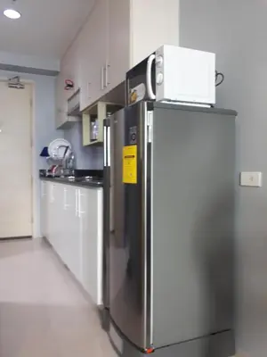 a stainless steel refrigerator in a kitchen with white cabinets at 5 Years Legit Staycation Infront of Moa, Arena, Smx, Ikea, Sea Residences Tower A, Near Dfa Macapagal, Ayala Mall, World Trade, Naia123 in Manila