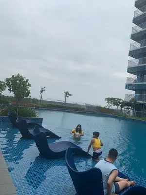a group of people playing in a swimming pool at Le Maisse Executive Studio 1BR opp Okada in Manila