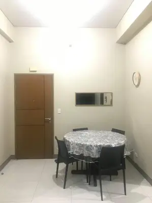 a dining room with a table and chairs and a television at Lovely 2 Bed Room condo infront of NAIA Terminal 3 in Manila