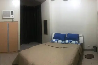 a bedroom with a bed with blue pillows at Lovely 2 Bed Room condo infront of NAIA Terminal 3 in Manila