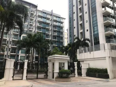 a building with palm trees in front of a building at Lovely 2 Bed Room condo infront of NAIA Terminal 3 in Manila