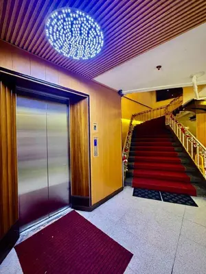 a hallway with a staircase with a red carpet at Comfy Inn Mabini Manila in Manila