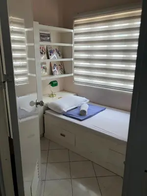 a room with a window with a bed and a window sill at 2 separate fully furnished condo units 1BR on the 23rd flr and 3BR penthouse on the 41st flr, with different bookings and daily rates in Ermita, Manila near SLEC,US Embassy, Mall and Parks in Manila