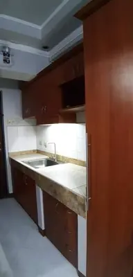 a kitchen with a sink and a counter top at 2 separate fully furnished condo units 1BR on the 23rd flr and 3BR penthouse on the 41st flr, with different bookings and daily rates in Ermita, Manila near SLEC,US Embassy, Mall and Parks in Manila