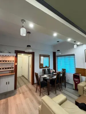 a dining room and living room with a table and chairs at 2 separate fully furnished condo units 1BR on the 23rd flr and 3BR penthouse on the 41st flr, with different bookings and daily rates in Ermita, Manila near SLEC,US Embassy, Mall and Parks in Manila