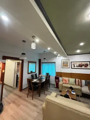 a living room with a couch and a table at 2 separate fully furnished condo units 1BR on the 23rd flr and 3BR penthouse on the 41st flr, with different bookings and daily rates in Ermita, Manila near SLEC,US Embassy, Mall and Parks in Manila