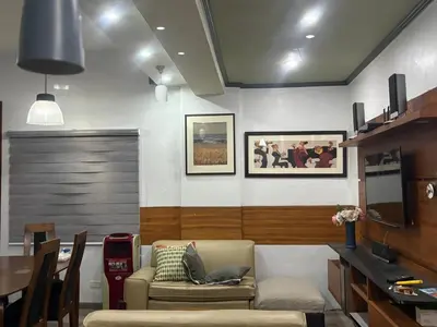 a living room with a couch and a table at 2 separate fully furnished condo units 1BR on the 23rd flr and 3BR penthouse on the 41st flr, with different bookings and daily rates in Ermita, Manila near SLEC,US Embassy, Mall and Parks in Manila