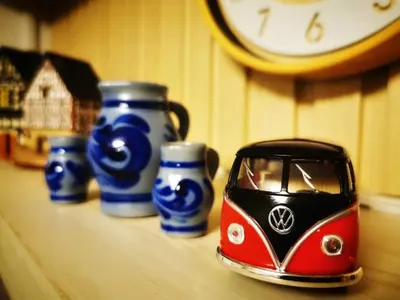 a small toy car sitting on a table with a clock at Awesome Value, Great Location in Manila