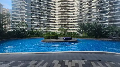 a swimming pool in front of a large building at Awesome Value, Great Location in Manila