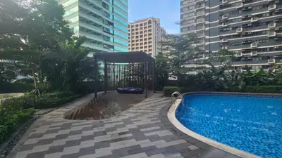a swimming pool in the middle of a city with buildings at Awesome Value, Great Location in Manila
